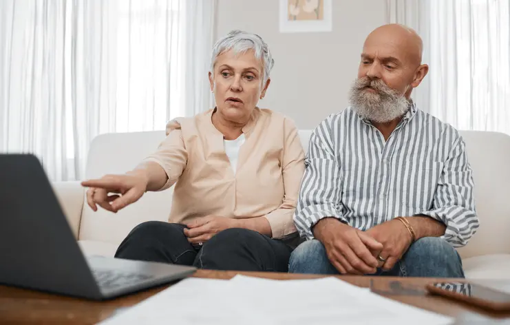 Budget, finance and senior couple with laptop planning financial investments, mortgage or tax papers. Elderly woman apeaking of bills, debt and pension fund on bank statement with an old man at home Budget, finance and senior couple with laptop planning financial investments, mortgage or tax papers. Elderly woman apeaking of bills, debt and pension fund on bank statement with an old man at home